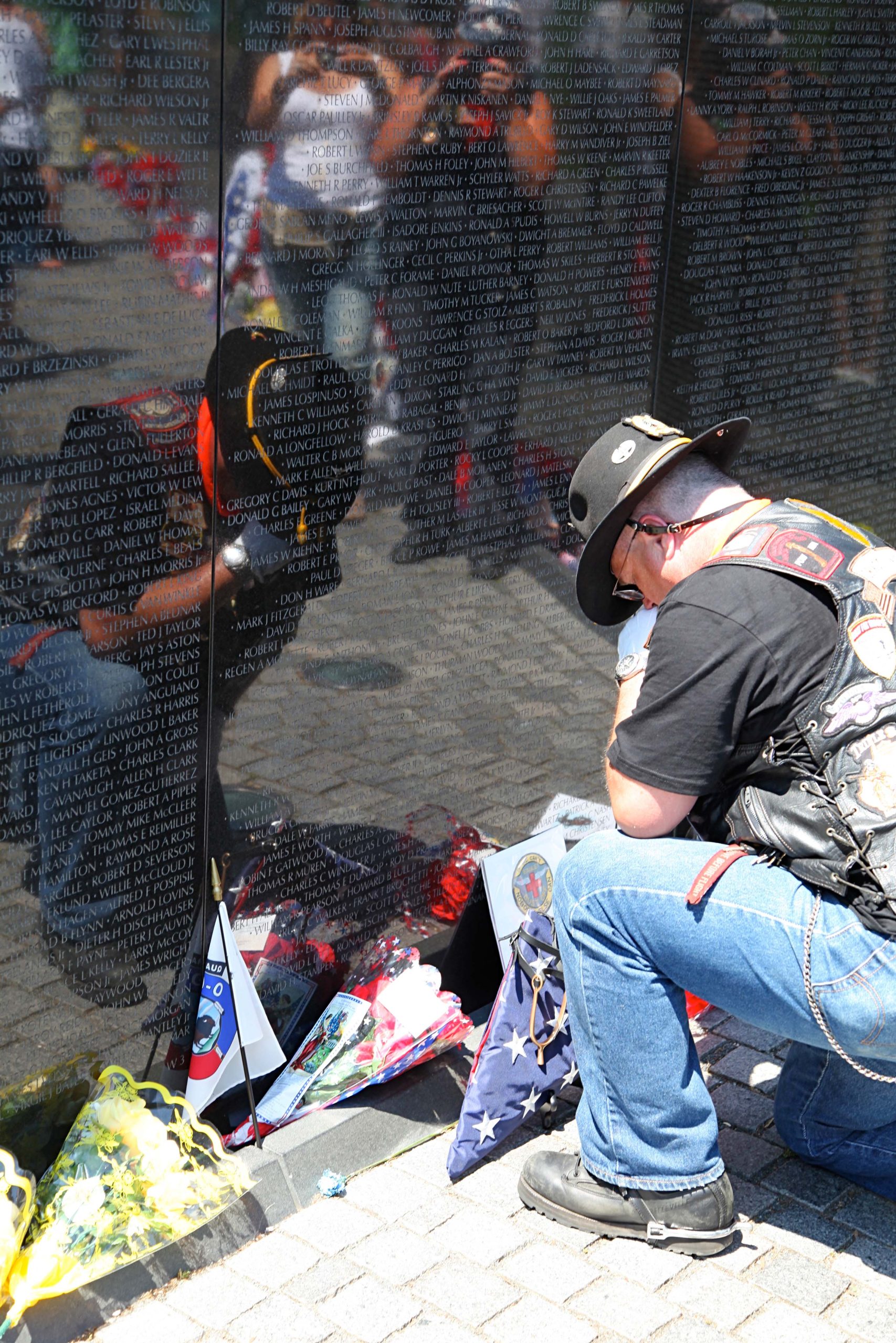 Vietnam Veteran laying flag at the Memorial in Washington 